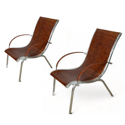 A PAIR OF MIDCENTURY LEATHER ARMCHAIRS